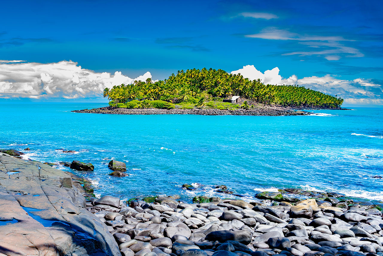 Rocky coastline and lush tropical landscape of Devil's Island, the most famous of the Salvation Islands off the coast of French Guiana